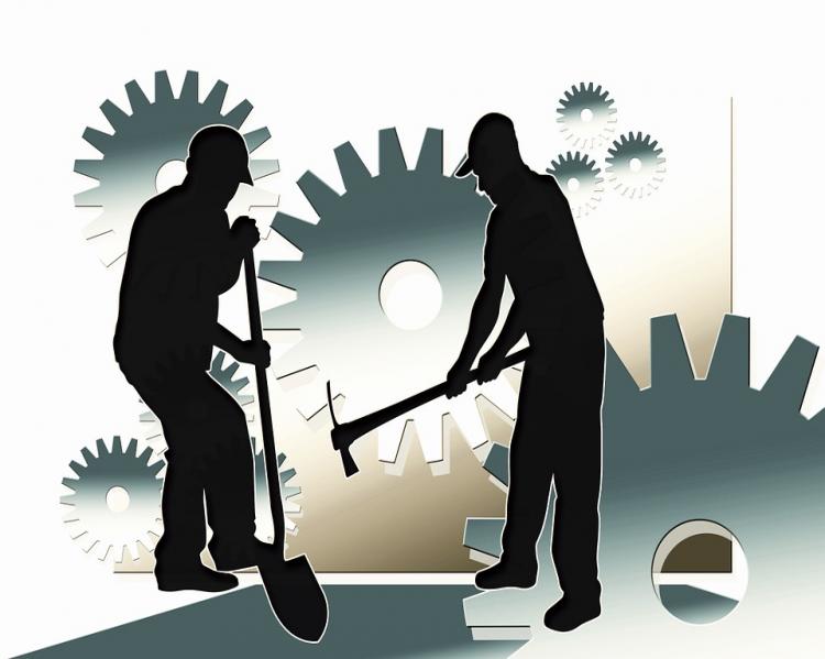 Ilustração em preto e branco mostra silhueta de dois homens segurando picaretas, com engrenagens ao fundo